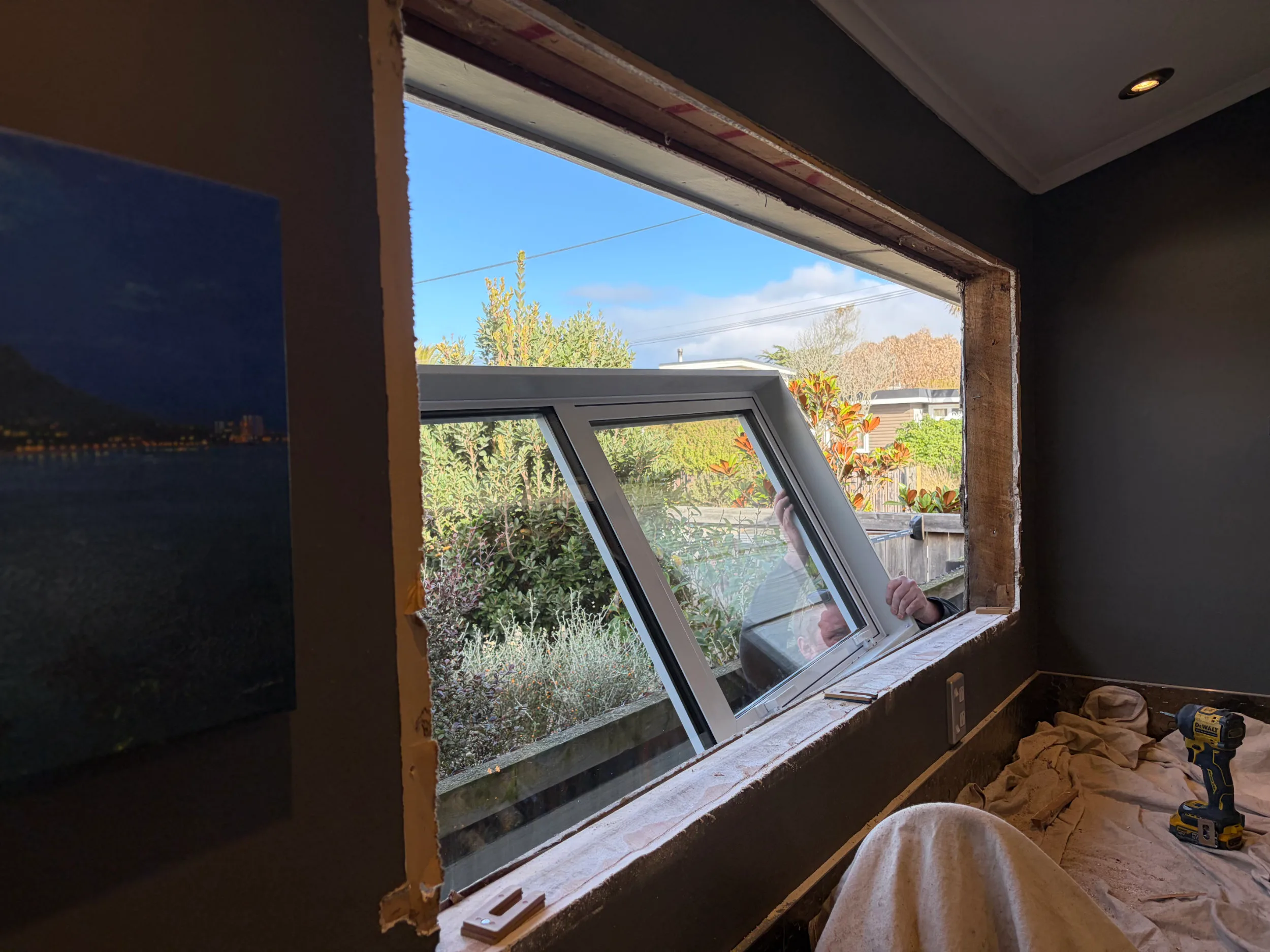 New aluminium units being fitted and weather-sealed into an opening during a full replacement